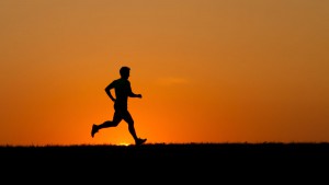 Silhouetted man jogging